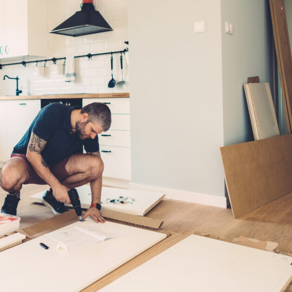 Mid adult man assembling wardrobe for his new home